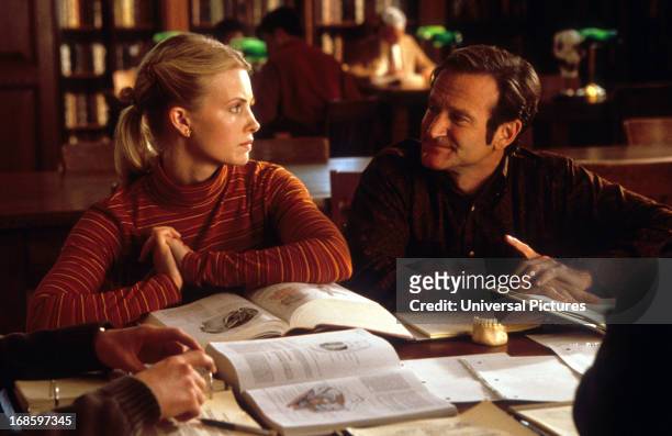 Monica Potter sits with Robin Williams in a scene from the film 'Patch Adams', 1998.