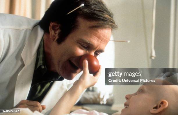 Robin Williams visits a sick child in a scene from the film 'Patch Adams', 1998.