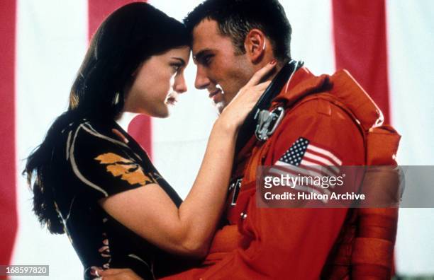 Liv Tyler and Ben Affleck embrace in a scene from the film 'Armageddon', 1998.