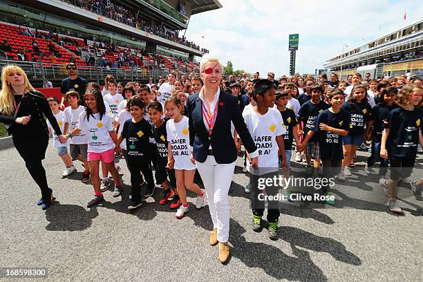 María de Villota leads a group of children during an event to promote the F.I.A. Safer Roads For All campaign before the Spanish Formula One Grand...