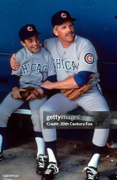 Thomas Ian Nicholas on dugout bench with Gary Busey in a scene from the film 'Rookie Of The Year', 1993.