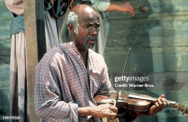Louis Gossett Jr holding violin in a scene from the Television Series 'Roots', 1977.