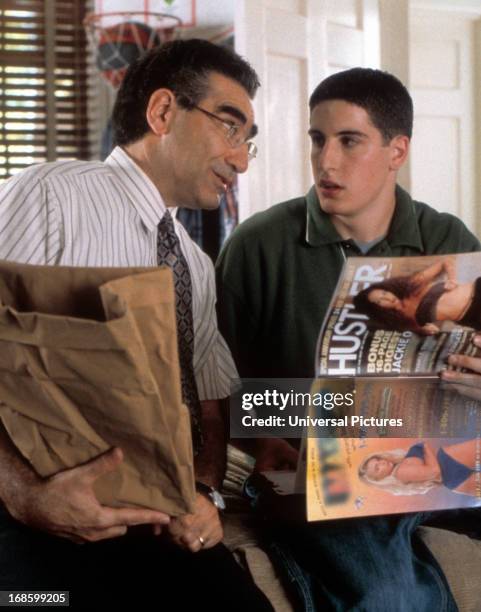 Eugene Levy having awkward conversation with Jason Biggs over Hustler Magazine in a scene from the film 'American Pie', 1999.