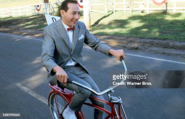 Paul Reubens rides a bike in a scene from the film 'Pee-Wee's Big Adventure', 1985.