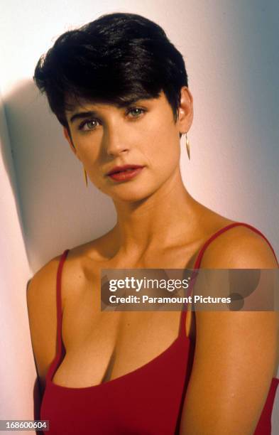 Demi Moore with short hair and wearing a spaghetti strap top, circa 1990.