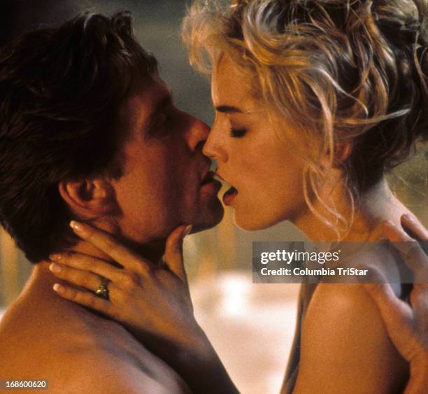 Michael Douglas and Sharon Stone kissing in scene from the film 'Basic Instinct', 1992.