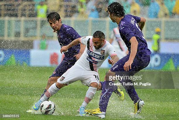 Fabrizio Miccoli of Palermo is challenged by Matias Fernandez and Ahmed Hegazi of Fiorentina compete for the ball during the Serie A match between...