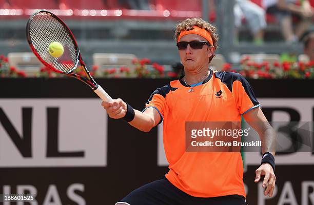 Denis Istomin of Uzbekistan plays a forehand against John Isner of the USA in their first round match during day one of the Internazionali BNL...