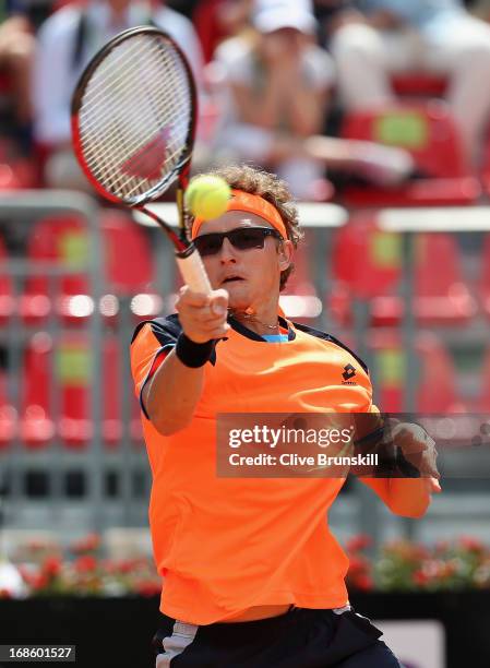 Denis Istomin of Uzbekistan plays a forehand against John Isner of the USA in their first round match during day one of the Internazionali BNL...