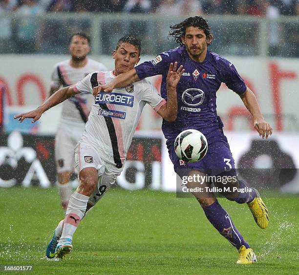 Paulo Dybala of Palermo and Ahmed Hegazi of Fiorentina compete for the ball during the Serie A match between ACF Fiorentina and US Citta di Palermo...