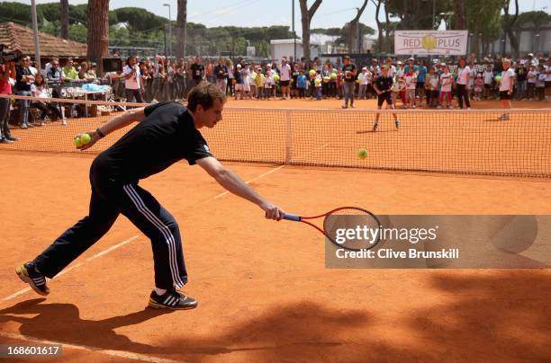 Andy Murray of Great Britain plays tennis with young children during day one of the Internazionali BNL d'Italia 2013 at the Foro Italico Tennis...