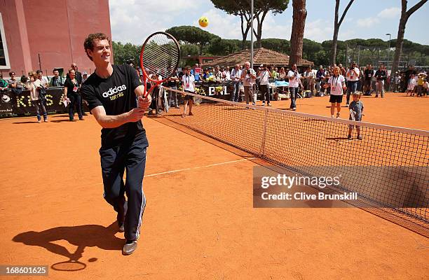 Andy Murray of Great Britain plays tennis with a young child during day one of the Internazionali BNL d'Italia 2013 at the Foro Italico Tennis Centre...