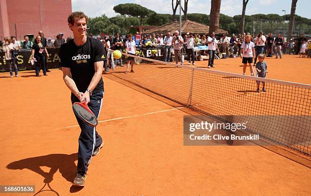 Andy Murray of Great Britain plays tennis with a young child during day one of the Internazionali BNL d'Italia 2013 at the Foro Italico Tennis Centre...