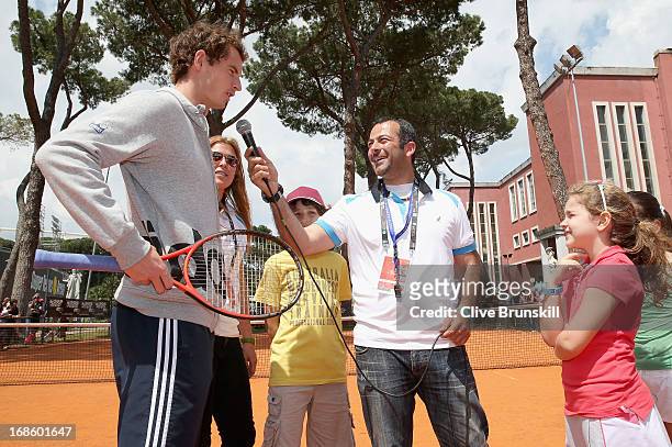 Andy Murray of Great Britain answers young chidrens questions after playing tennis with them during day one of the Internazionali BNL d'Italia 2013...