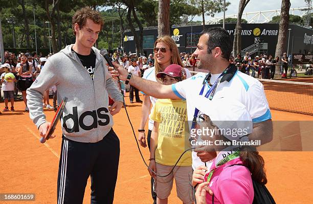 Andy Murray of Great Britain answers young chidrens questions after playing tennis with them during day one of the Internazionali BNL d'Italia 2013...