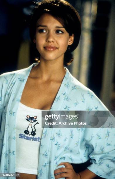 Jessica Alba standing with her hand on her hip with a smirk on her face in a scene from the film 'Idle Hands', 1999.