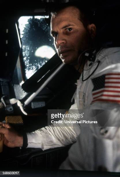 Bill Paxton sitting in ship in a scene from the film 'Apollo 13', 1995.
