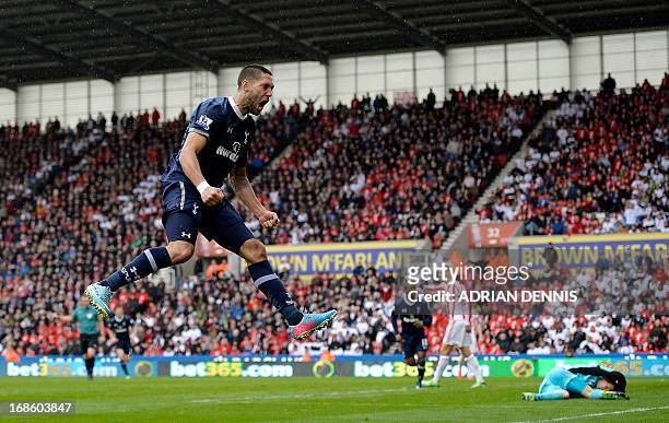 Tottenham Hotspur's US striker Clint Dempsey jumps to celebrate after providing the cross for teammate Emmanuel Adebayor to score a late winning goal...