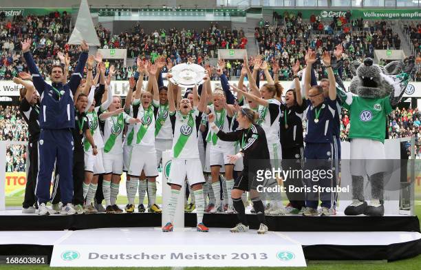 Players of Wolfsburg celebrate with the trophy on the podium after winning the German championship after the Women's Bundesliga match between VfL...