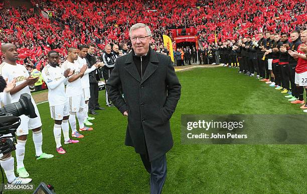 Manager Sir Alex Ferguson of Manchester United is given a guard of honour by both teams ahead of the Barclays Premier League match between Manchester...