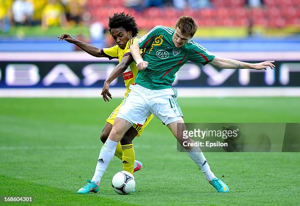 Oleg Ivanov of FC Terek Grozny is challenged by Willian of FC Anzhi Makhachkala during the Russian Premier League match between FC Terek Grozny and...