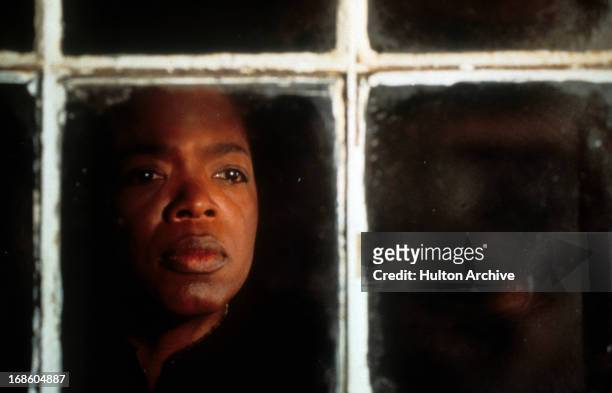 Oprah Winfrey looking out a window in a scene from the film 'Beloved', 1998.