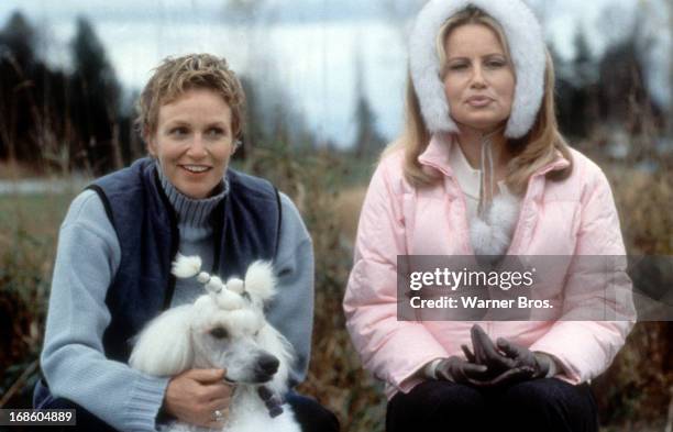 Carrie Aizley holding a dog next to Jennifer Coolidge in a scene from the film 'Best In Show', 2000.