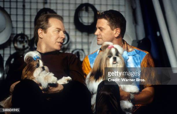 Michael McKean and John Michael Higgins both holding a dog in a scene from the film 'Best In Show', 2000.