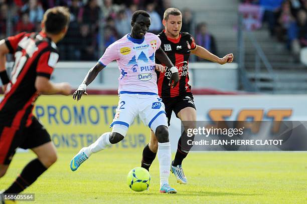 Evian's Ghanaian midfielder Mohammed Rabiu vies with Nice's Dutch midfielder Luigi Bruins during a French L1 football match between Evian and Nice on...