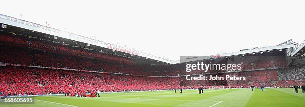 Manchester United wave red flags ahead of the Barclays Premier League match between Manchester United and Swansea at Old Trafford on May 12, 2013 in...