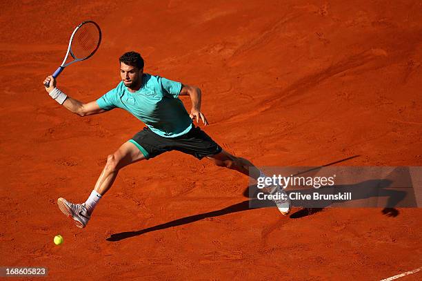 Grigor Dimitrov of Bulgaria leaps to play a forehand against Marcos Baghdatis of Cyprus in their first round match during day one of the...