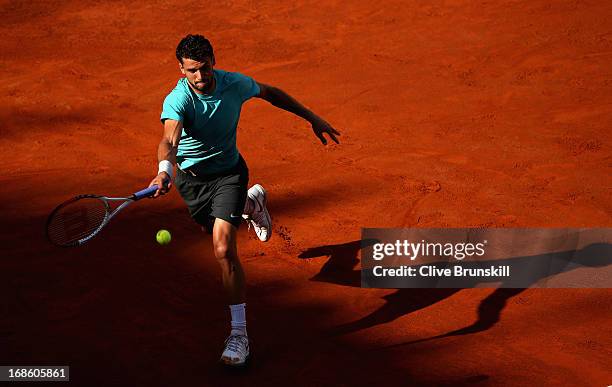 Grigor Dimitrov of Bulgaria runs to play a forehand against Marcos Baghdatis of Cyprus in their first round match during day one of the...