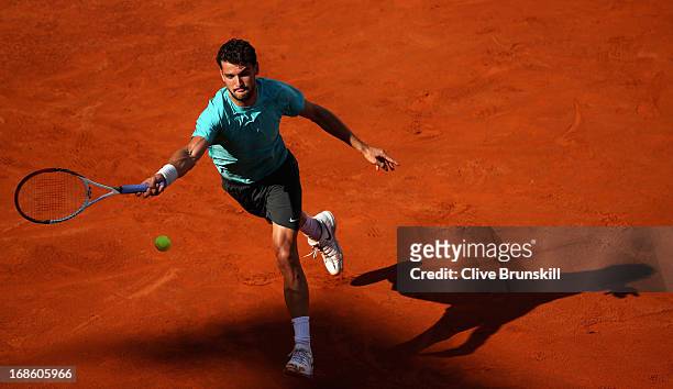 Grigor Dimitrov of Bulgaria stretches to play a forehand against Marcos Baghdatis of Cyprus in their first round match during day one of the...
