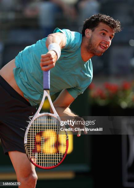 Grigor Dimitrov of Bulgaria serves against Marcos Baghdatis of Cyprus in their first round match during day one of the Internazionali BNL d'Italia...