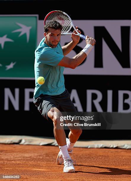 Grigor Dimitrov of Bulgaria lines up a backhand against Marcos Baghdatis of Cyprus in their first round match during day one of the Internazionali...