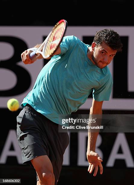 Grigor Dimitrov of Bulgaria plays a backhand against Marcos Baghdatis of Cyprus in their first round match during day one of the Internazionali BNL...