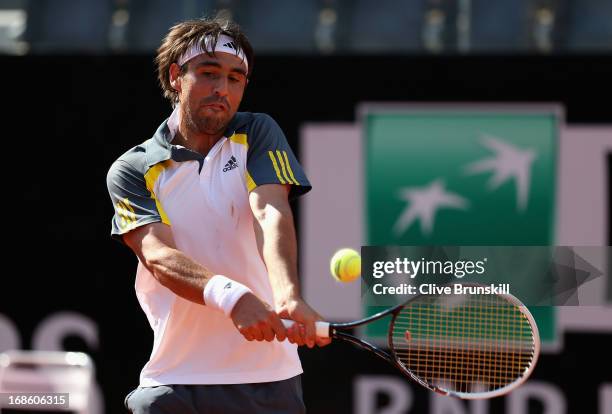 Marcos Baghdatis of Cyprus plays a backhand against Grigor Dimitrov of Bulgaria in their first round match during day one of the Internazionali BNL...