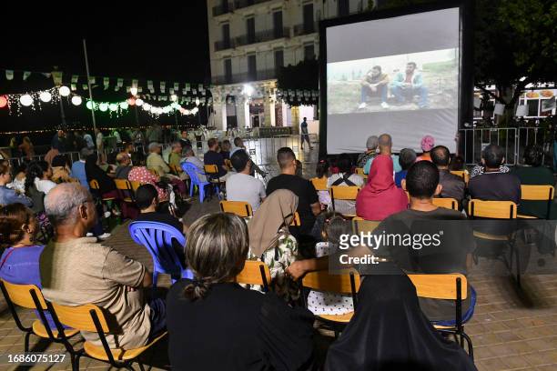 People attend the opening of the Cinematographic Meetings of Bejaia, a film and culture festival in Algeria's northern city of the same name, on...