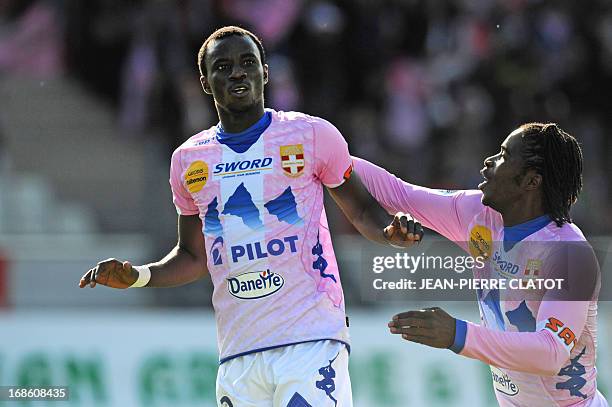 Evian's Ghanaian midfielder Mohammed Rabiu is congratulated by a teammate after scoring a goal during the French L1 football match Evian vs Nice on...