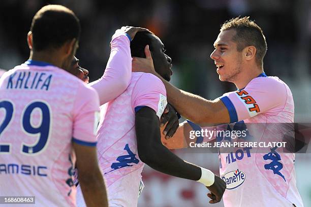 Evian's Ghanaian midfielder Mohammed Rabiu is congratulated by teammates after scoring a goal during the French L1 football match Evian vs Nice on...