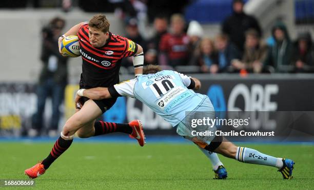 David Strettle of Saracens looks to get passed Northampton's Stephen Myler during the Aviva Premiership Semi Final match between Saracens and...