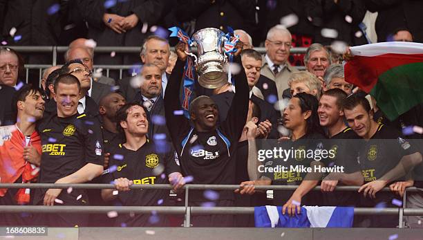 Arouna Kone of Wigan Athletic lifts the trophy after the FA Cup with Budweiser Final between Manchester City and Wigan Athletic at Wembley Stadium on...