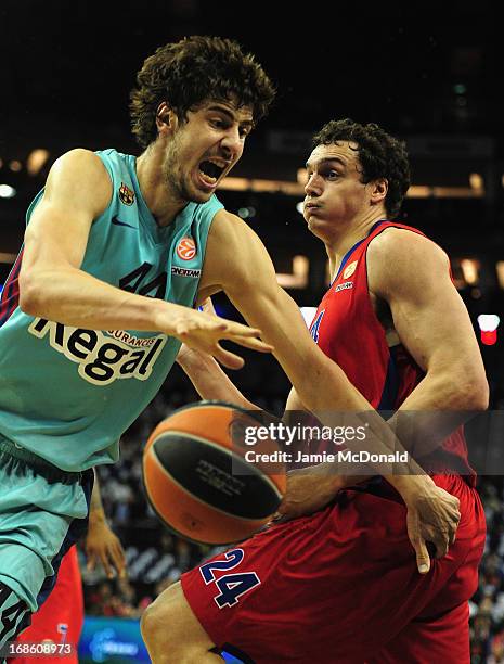 Ante Tomic of FC Barcelona tussles with Sasha Kaun of CSKA Moscow during the Turkish Airlines EuroLeague Final Four third place match between FC...