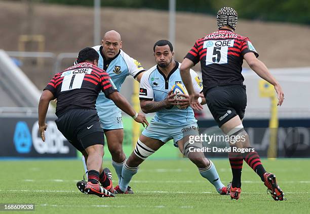 Samu Manoa, of Northampton takes on Mako Vunipola and Alistair Hargreaves during the Aviva Premiership semi final match between Saracens and...