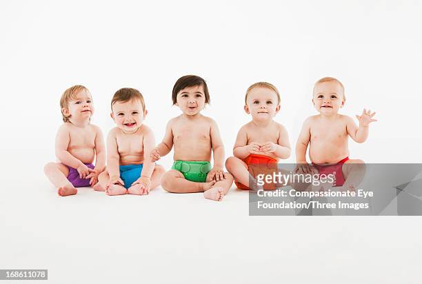 smiling babies sitting in a row - cinque persone foto e immagini stock