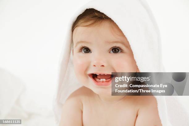 smiling baby wrapped in towel, close up - baby in towel stock pictures, royalty-free photos & images