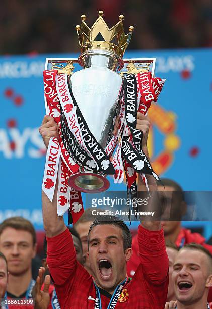 Robin van Persie of Manchester United lifts the Premier League trophy following the Barclays Premier League match between Manchester United and...