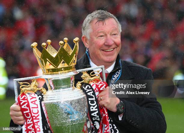 Manchester United Manager Sir Alex Ferguson celebrates with the Premier League trophy following the Barclays Premier League match between Manchester...