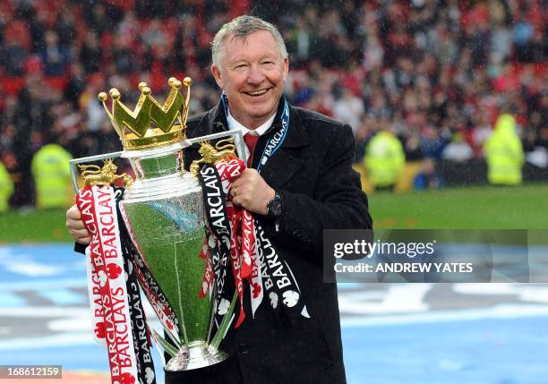 Manchester United's Scottish manager Alex Ferguson holds the Premier League trophy at the end of the English Premier League football match between...