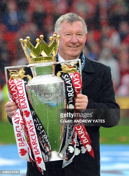 Manchester United's Scottish manager Alex Ferguson holds the Premier League trophy at the end of the English Premier League football match between...